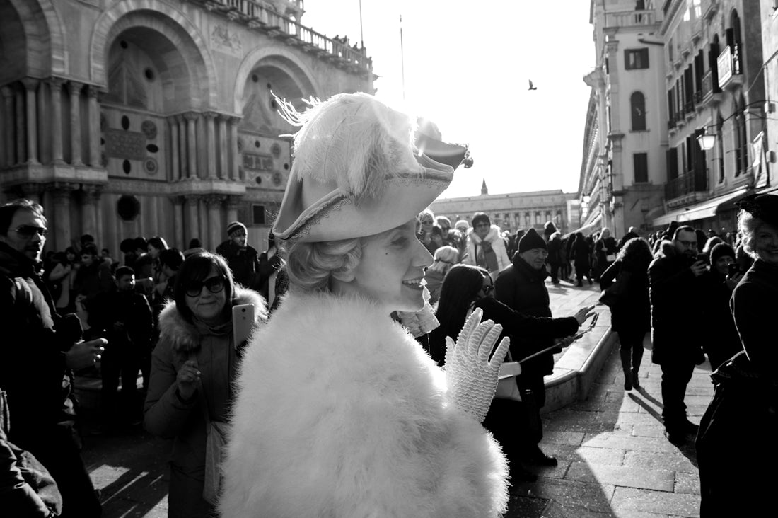 grayscale photography of woman near buildign