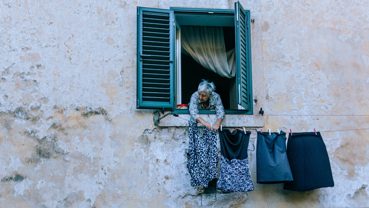 a woman is looking out of a window