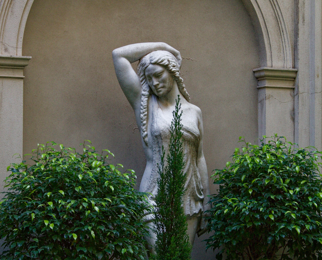 a statue of a woman holding her head in her hands