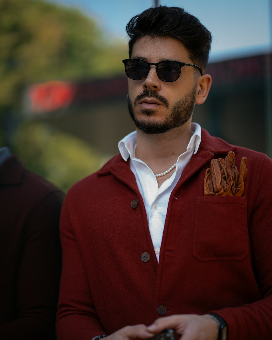 a man wearing a red jacket and sunglasses