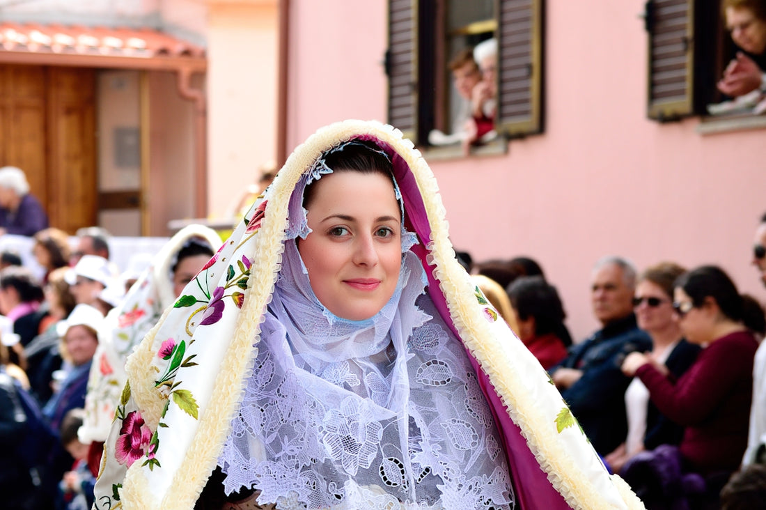 a woman in a white dress and a purple shawl