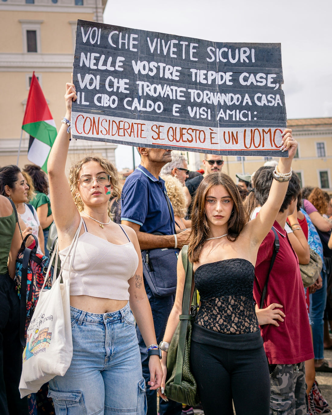 Two young women hold protest sign with sign