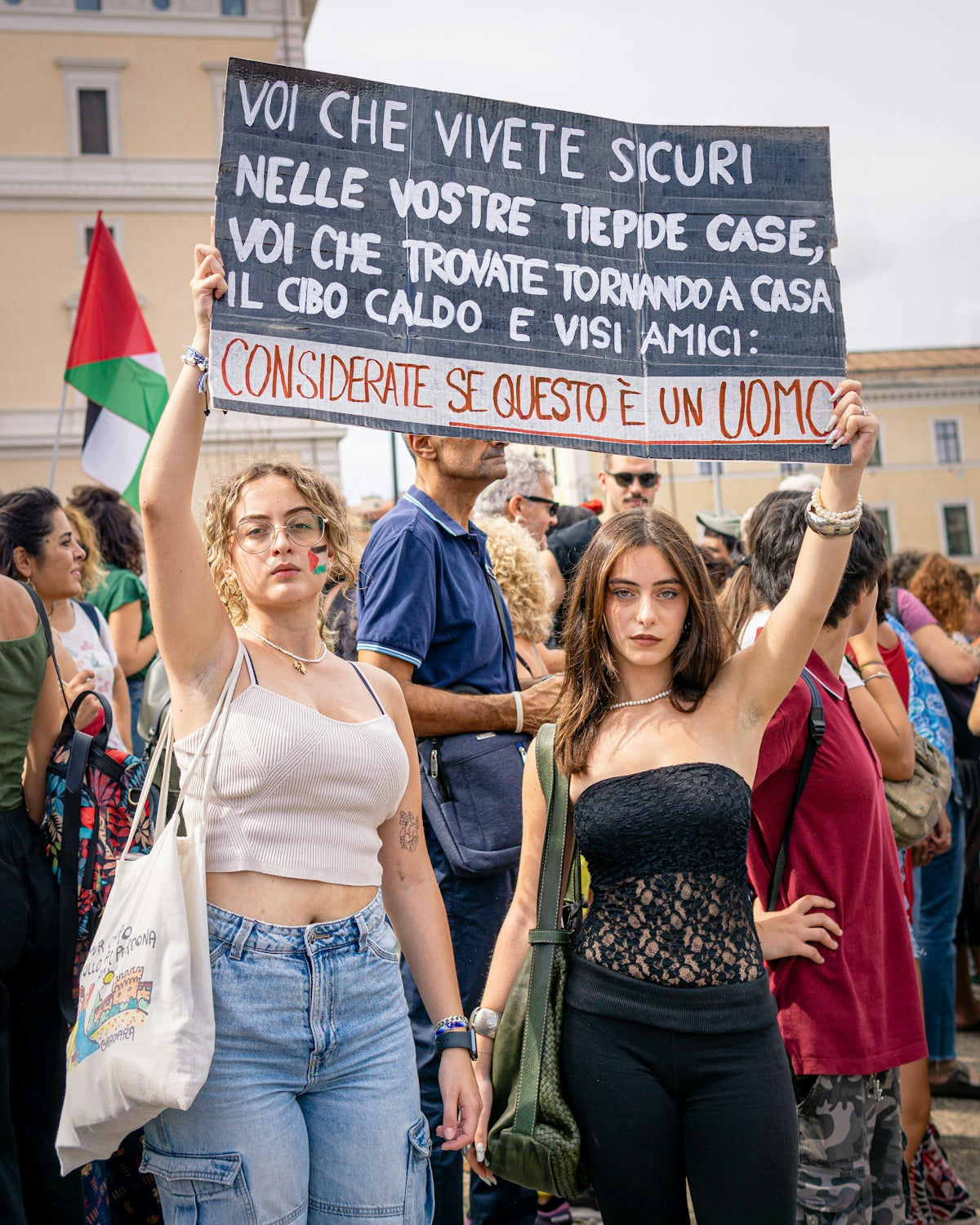 Two young women hold protest sign with sign